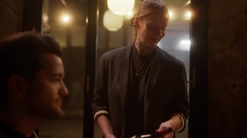 Waitress Serving Red Wine To Guest At A Restaurant