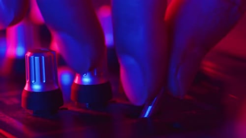 DJ Sound Control Console for Mixing Dance Music in Disco Club Closeup DJ Hands Twist and Press the