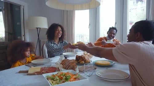 Happy Family Eating Dinner Together at Home