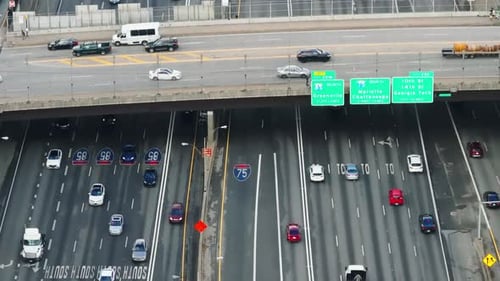 High angle view of cars driving on bridge above busy multilane highway. Transport infrastructure and