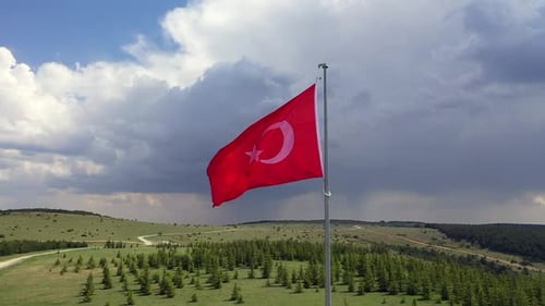 Waving Flag in Rural Green Landscape