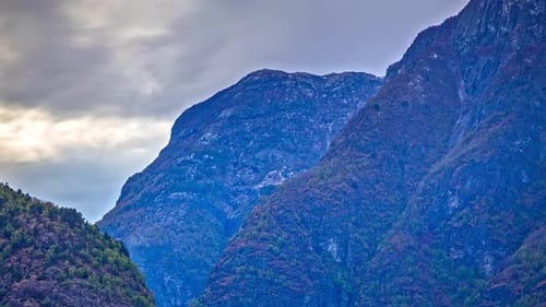 Evening mountain winter landscape. Panoramic view of mountains with rocks and ice in the mountains.