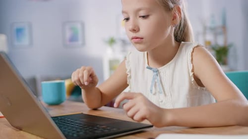 Girl Using Laptop at Home in Daytime