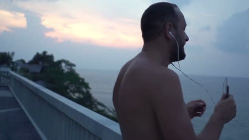 Happy Man Dancing While Listening to Music on Terrace Adult