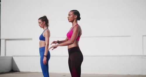 Athletic Women Stretching Arms in front of White Wall
