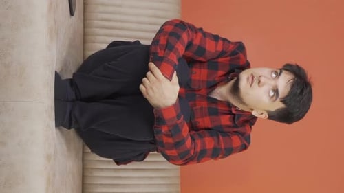 Vertical video of Man with Psychological Problems alone at home.