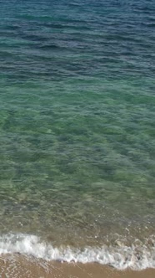 Turquoise Waters Shimmer Under the Sunlight Creating a Tranquil and Inviting Beach Scene Vertical
