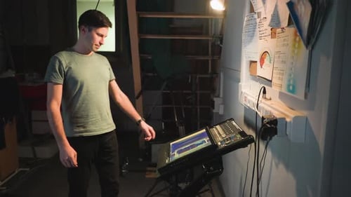 Technician Adjusts Editing Console in an Industrial Setting