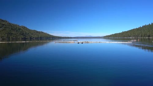 Calm and peaceful lake, forest, nature background. 4K stock footage.