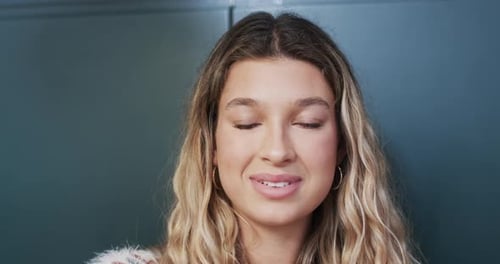 Smiling Woman Close-Up Indoors with Blonde Curly Hair