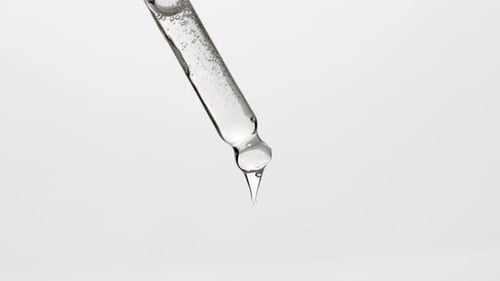 Dropper Releasing Clear Liquid in Close Up