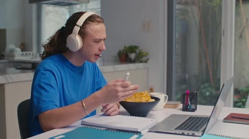 Young Adult Studying at Home with Laptop
