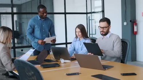 Business conception. Professional workers are in the modern office together.