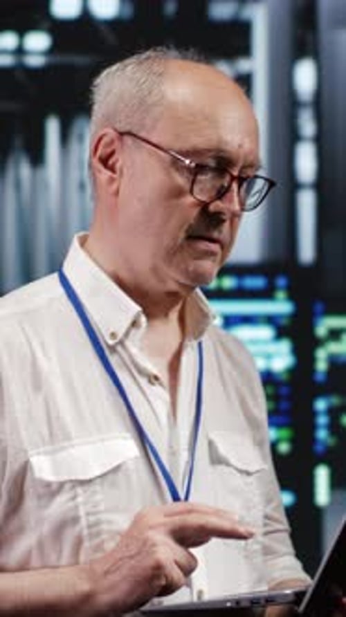 Man Working on Laptop in an Office Environment