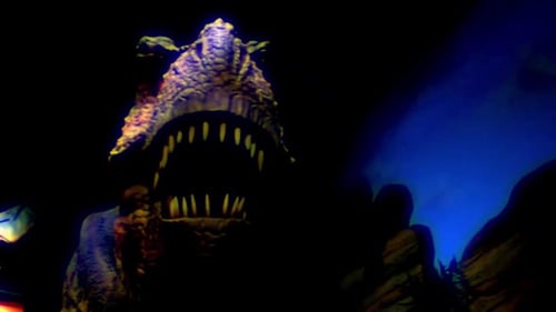 Animatronic dinosaur roaring on display in a building.