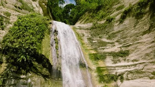 Scenic Waterfall Flowing Down Rocky Cliff
