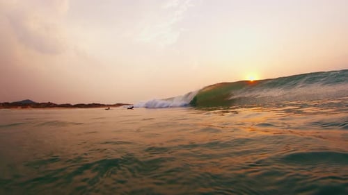 Ocean Wave Breaks in the Ocean at Sunrise