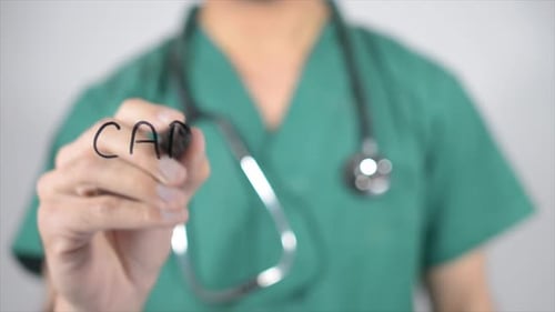 Doctor Writing Cardiologist Word on Clear Surface