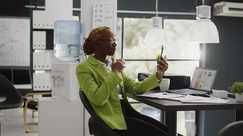 Woman Video Chats in Modern Office Setting