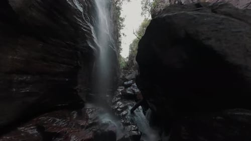 Traversing the dramatic, deep canyon of River Sao Miguel with rugged rock formations