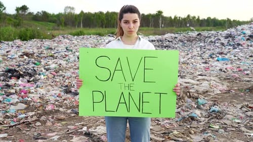 Woman Protesting Waste with Save the Planet Sign