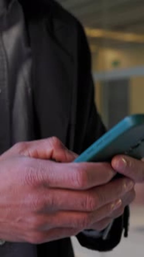 Unrecognizable Businessman Using Smartphone in Modern Office Building