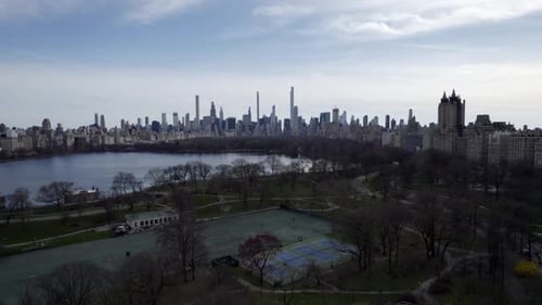 Central Park The Lake and Leisure Courts with Sunny Manhattan Skyline
