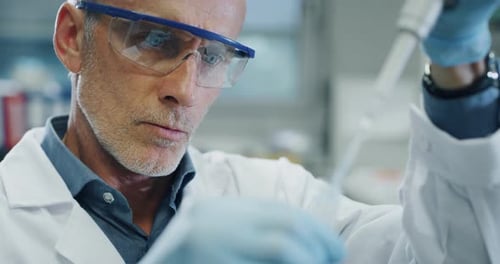 Scientist Conducting Research in Laboratory with Pipette