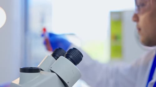 Scientist Examining Sample in Bright Modern Lab