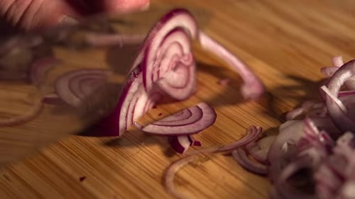 Slicing Red Onion on Wooden Cutting Board