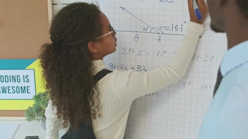 Student Solving Equations on Whiteboard