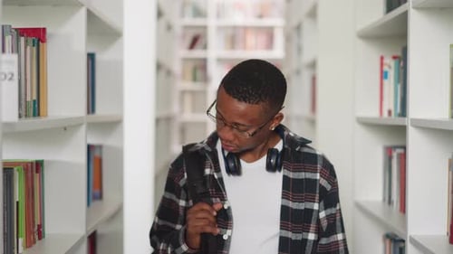 Black Man Looks Around in Public Library