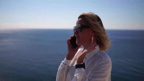 Business Woman Talking By Phone on the Sea