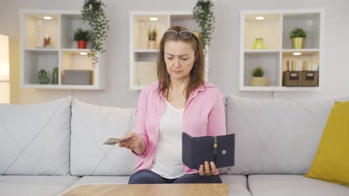Desperate woman with little money, thoughtful.