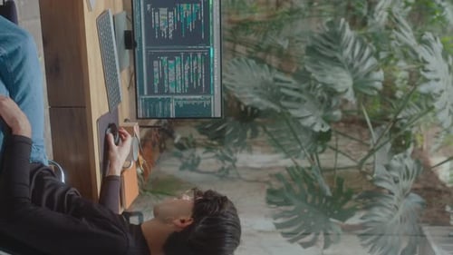 IT Developer Scrolling through Computer Code on PC