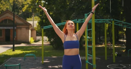Red-Haired Woman Practicing Yoga Outdoors