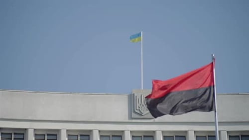 Flags Flapping atop Government Building on Bright Day