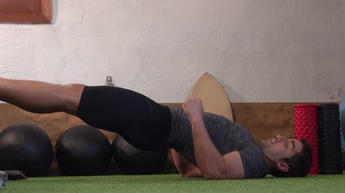 Young Adult Doing Glute Bridges on Mat