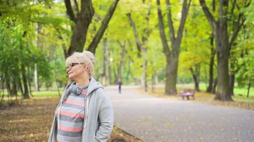 Senior Active Woman Walks in the Park or Forest. Portrait an old 50s or 60s Attractive Female Relax