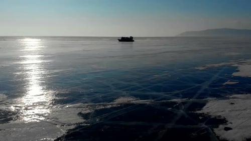 Aerial View of the Frozen Winter Lake Baikal and Khivus Amphibious Hovercraft Top View of Deep