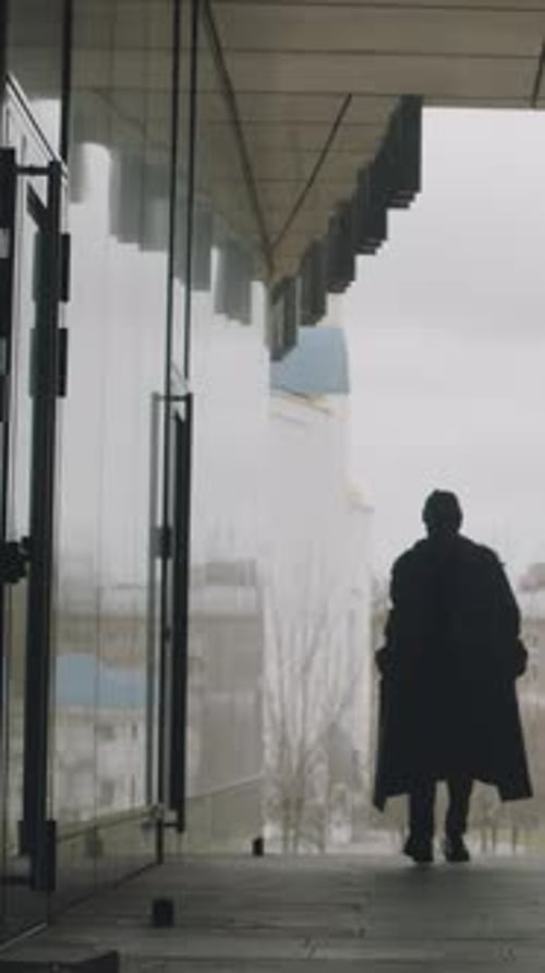 Vertical of Young Man Walking in City