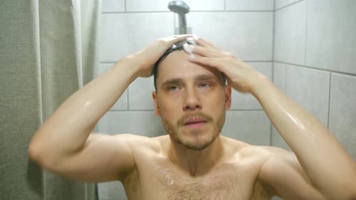 Man Washing Hair with Shampoo in Slow Motion