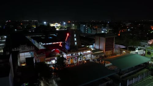 Aerial pan shot of a religious temple located at South India during night.