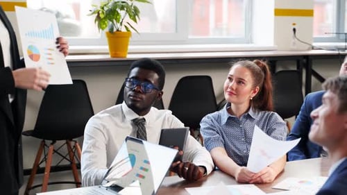 Business Team in Office Meeting With Presentation