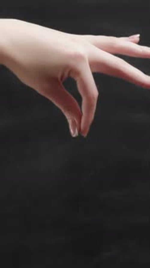 Hand Snapping Fingers on Black Background