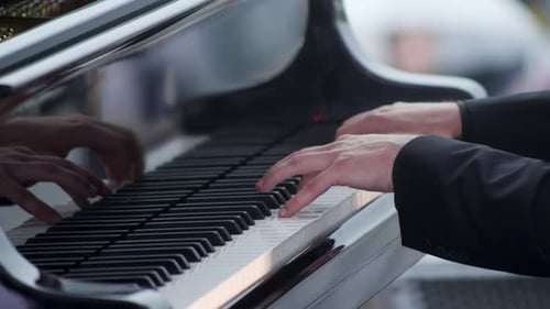 Close Up of Hands Playing Piano