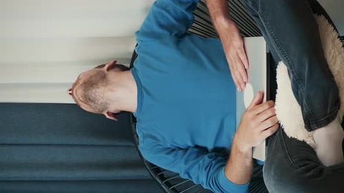 Young Adult Works On Laptop At Home