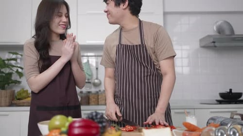 Happy Couple Cooking Healthy Meal Together in Kitchen