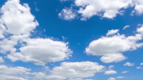 White soft clouds quickly transforming in the sky. Low angle view timelapse on summer daytime.