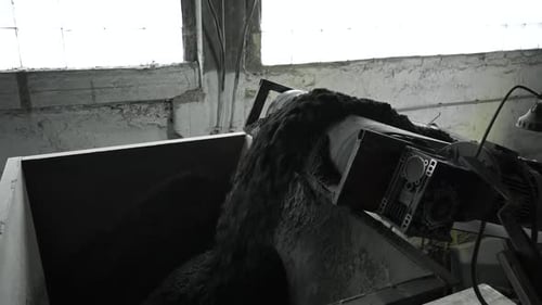 Close up of conveyor belt with crushed stone, shooting in slow motion.